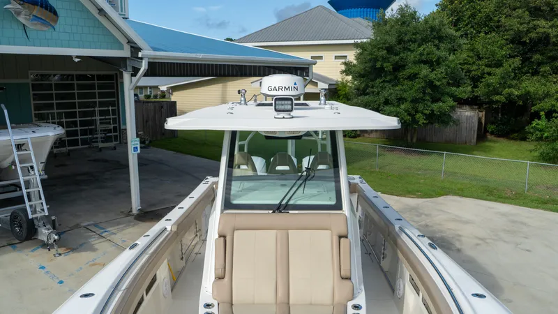  Yacht Photos Pics 2020 Sailfish 360 CC boat with Garmin equipment, docked near a house.