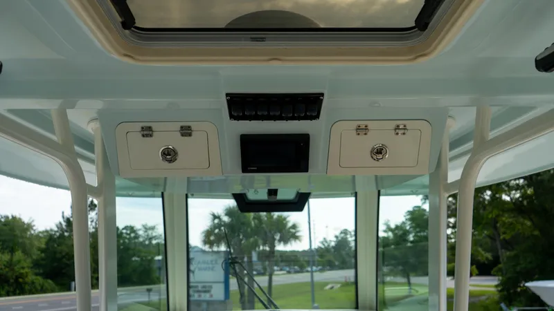  Yacht Photos Pics 2020 Sailfish 360 CC boat interior with overhead storage and control panel.