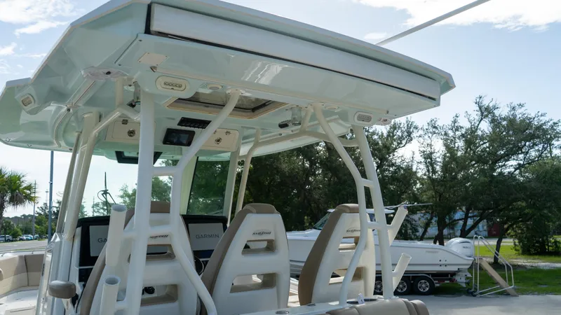 Yacht Photos Pics 2020 Sailfish 360 CC boat interior with seating and canopy, parked outdoors.