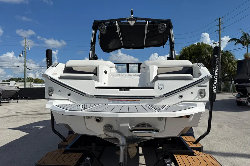  Yacht Photos Pics 2022 Nautique Super Air Nautique G23 boat rear view, showcasing sleek design and seating.