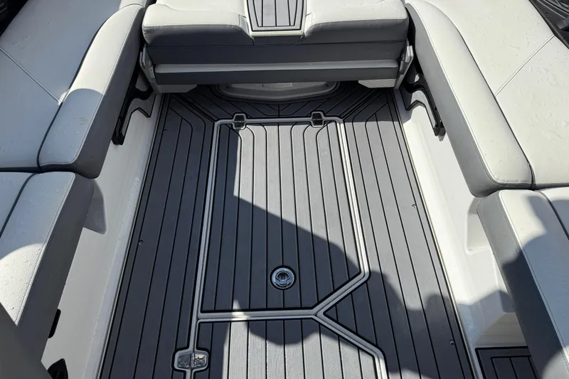  Yacht Photos Pics 2022 Nautique Super Air Nautique G23 interior with gray deck and cushioned seating.