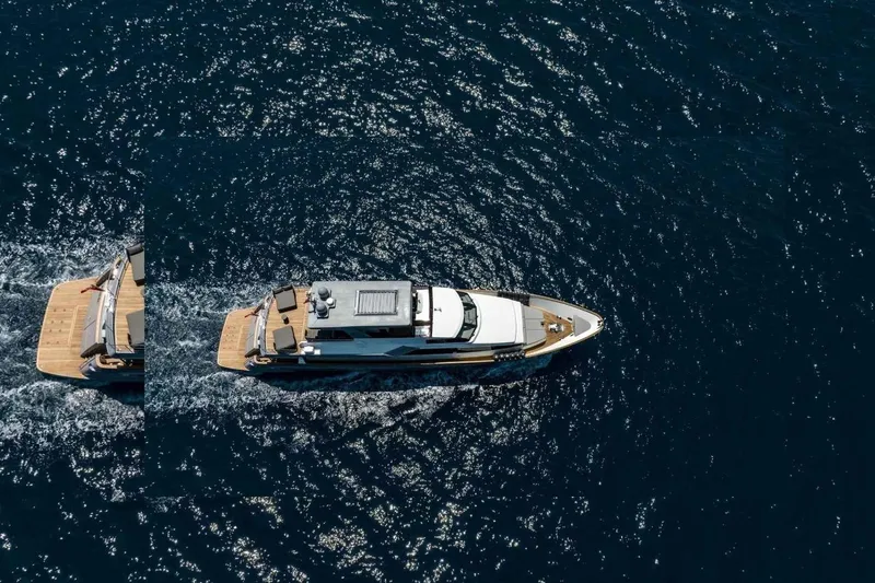  Yacht Photos Pics Aerial view of 1985 Heesen Pleasure Vessel cruising on open water.