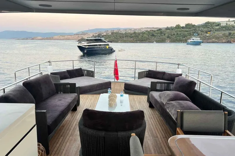  Yacht Photos Pics Luxurious 1985 Heesen Pleasure Vessel with elegant deck seating, overlooking serene waters.