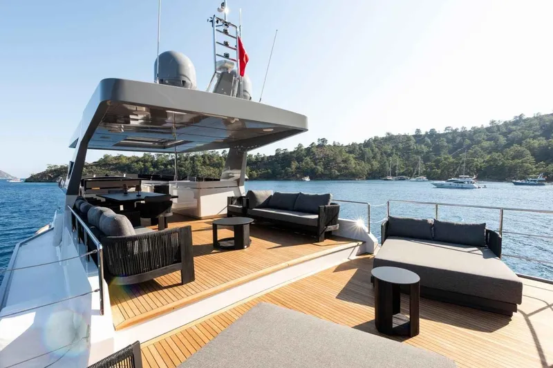  Yacht Photos Pics Luxurious 1985 Heesen Pleasure Vessel with spacious deck, elegant seating, and scenic ocean view.