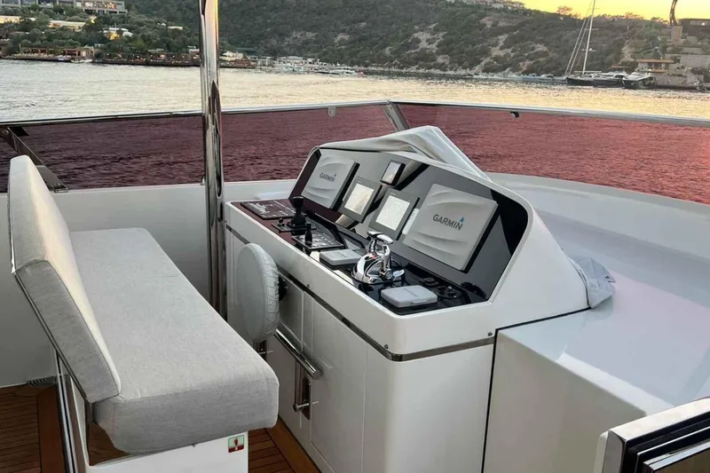  Yacht Photos Pics Helm of 1985 Heesen Pleasure Vessel with Garmin navigation, overlooking scenic waterfront.