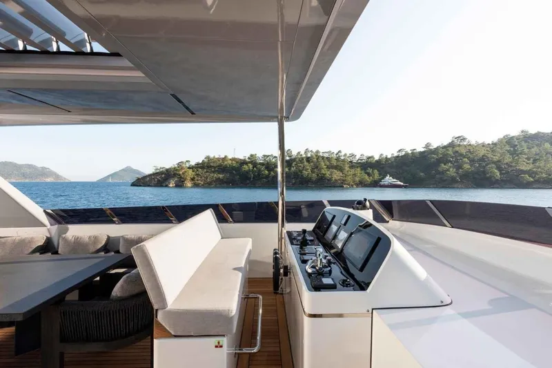  Yacht Photos Pics Luxurious 1985 Heesen Pleasure Vessel with modern helm, scenic ocean view.