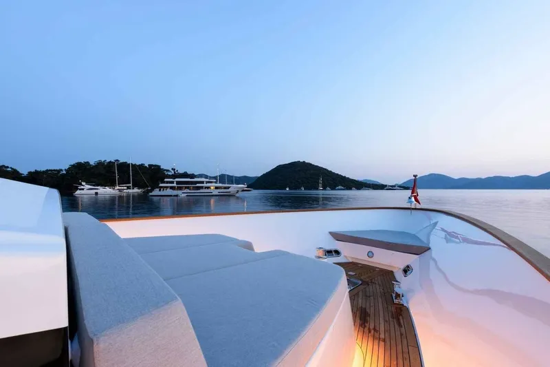  Yacht Photos Pics Luxurious 1985 Heesen pleasure vessel at sunset, featuring elegant deck seating and serene waters.