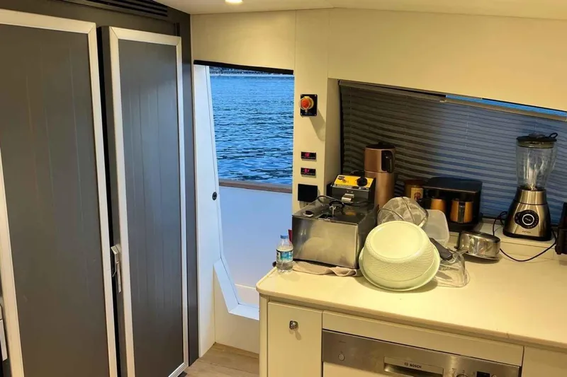  Yacht Photos Pics Interior of 1985 Heesen Pleasure Vessel kitchen with appliances and sea view.