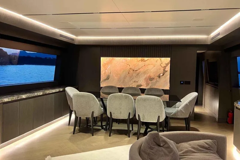  Yacht Photos Pics Luxurious dining area on 1985 Heesen Pleasure Vessel with elegant decor and scenic window views.