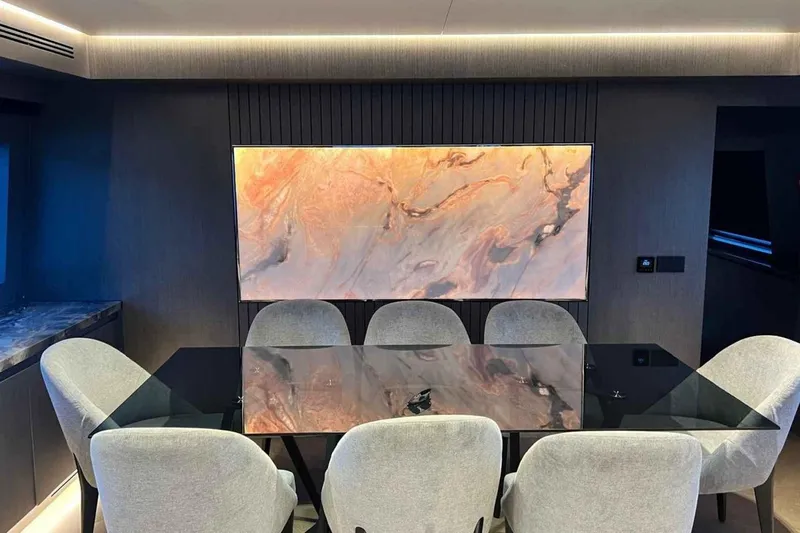  Yacht Photos Pics Luxurious dining area on 1985 Heesen Pleasure Vessel with elegant decor and modern art.