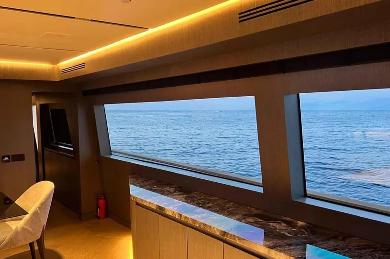  Yacht Photos Pics Luxurious interior of 1985 Heesen Pleasure Vessel with ocean view through large windows.