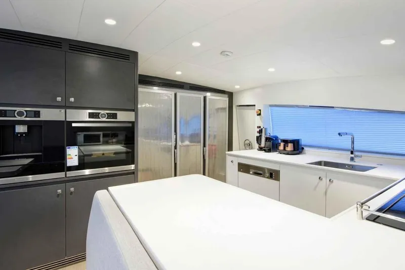 Yacht Photos Pics Modern kitchen interior on 1985 Heesen Pleasure Vessel, featuring sleek appliances and minimalist design.