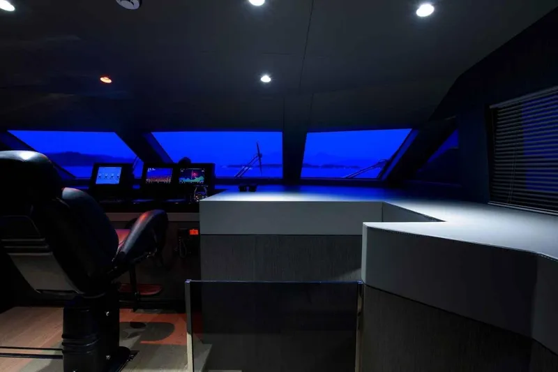  Yacht Photos Pics Control room of 1985 Heesen Pleasure Vessel with modern navigation equipment and blue-lit windows.