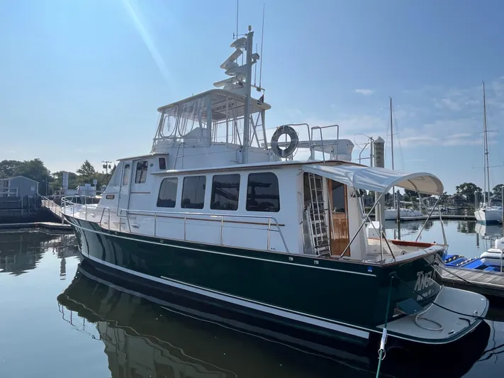 Angus III Yacht Photos Pics 1998 Alden 56 PHMY yacht docked in a sunny marina.