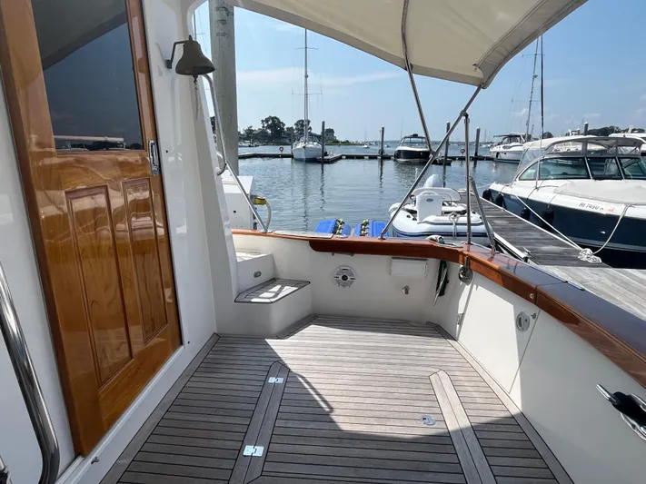 Angus III Yacht Photos Pics Alden 56 PHMY 1998 yacht deck with wooden flooring, docked at marina.