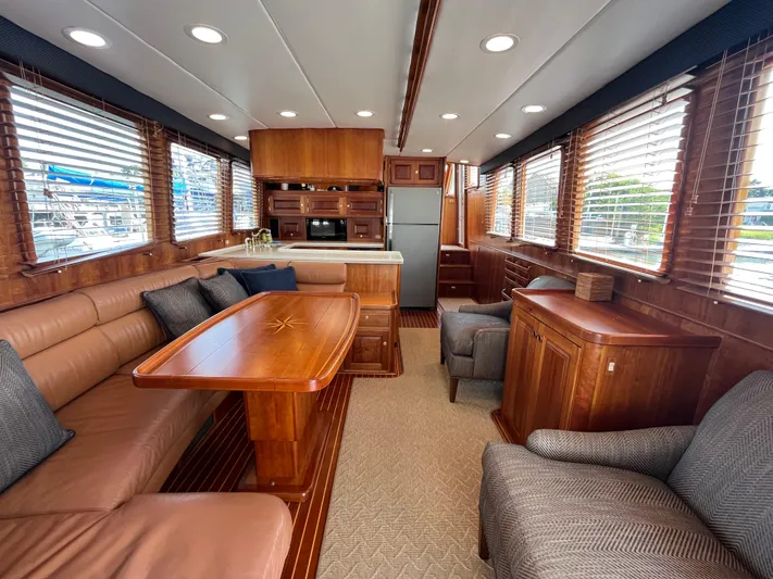 Angus III Yacht Photos Pics Luxurious interior of 1998 Alden 56 PHMY yacht with wood finishes and comfortable seating.