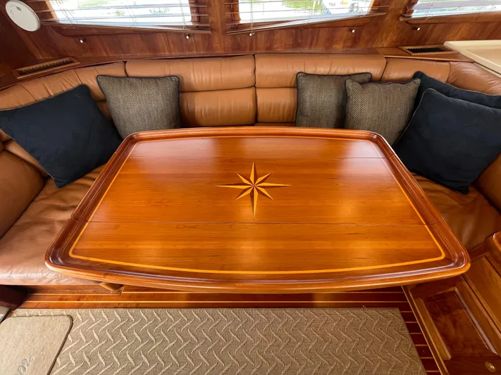 Angus III Yacht Photos Pics Luxurious Alden 56 PHMY 1998 yacht interior with elegant wooden table and plush seating.