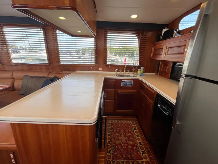 Angus III Yacht Photos Pics Luxurious kitchen interior of 1998 Alden 56 PHMY yacht with wood cabinetry and modern appliances.