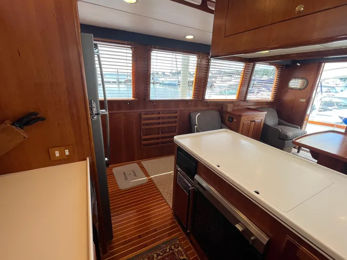 Angus III Yacht Photos Pics Interior of 1998 Alden 56 PHMY yacht with wood paneling and modern kitchen amenities.
