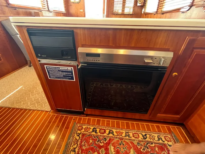 Angus III Yacht Photos Pics Interior of 1998 Alden 56 PHMY yacht with wooden cabinetry and appliances.