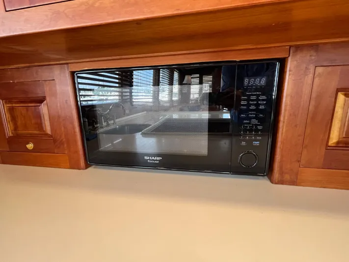 Angus III Yacht Photos Pics Built-in Sharp microwave in wooden kitchen cabinetry, Alden 56 PHMY, 1998 model.