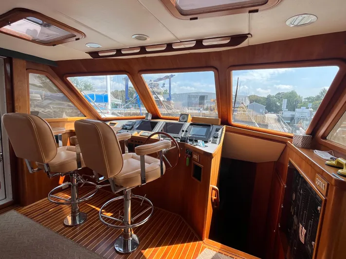 Angus III Yacht Photos Pics Interior of 1998 Alden 56 PHMY yacht with wooden helm and leather chairs.