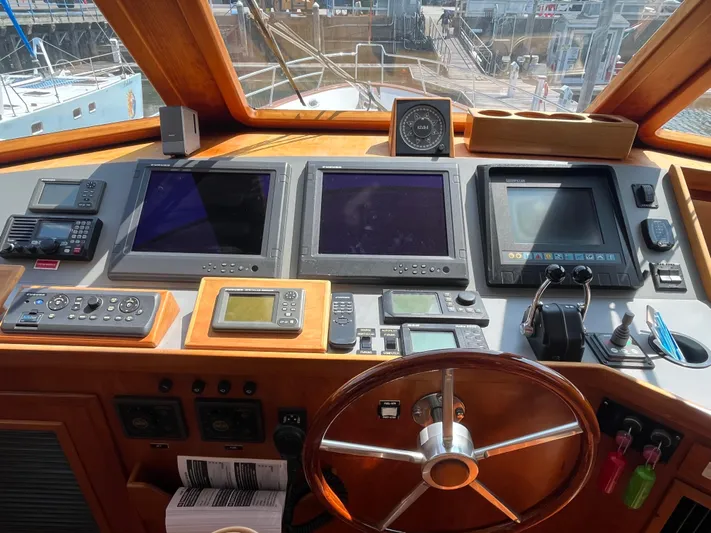 Angus III Yacht Photos Pics Cockpit of 1998 Alden 56 PHMY yacht with navigation equipment and steering wheel.