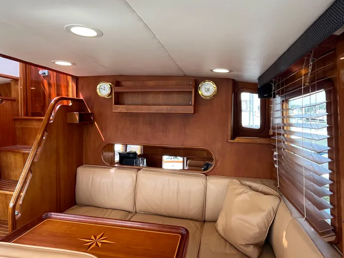 Angus III Yacht Photos Pics Luxurious interior of 1998 Alden 56 PHMY yacht with wooden accents and comfortable seating.