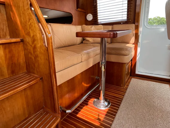 Angus III Yacht Photos Pics Interior of 1998 Alden 56 PHMY yacht with wooden finishes and beige seating.