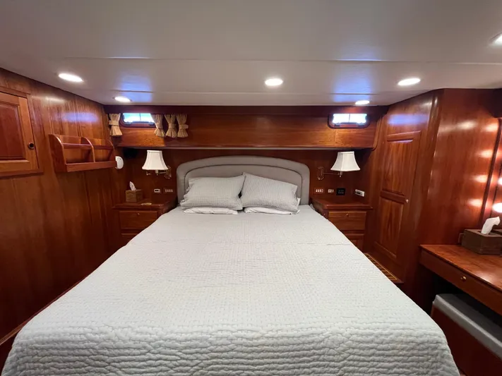 Angus III Yacht Photos Pics Luxurious wooden cabin interior of 1998 Alden 56 PHMY yacht with cozy bed and ambient lighting.