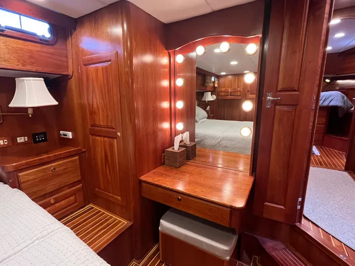 Angus III Yacht Photos Pics Luxurious wooden interior of 1998 Alden 56 PHMY yacht with vanity and lighting.