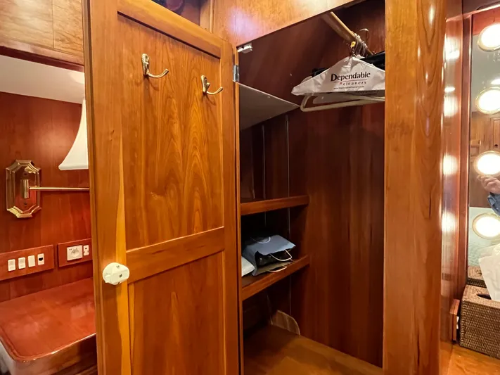 Angus III Yacht Photos Pics Wooden closet interior on 1998 Alden 56 PHMY yacht, featuring shelves and hangers.