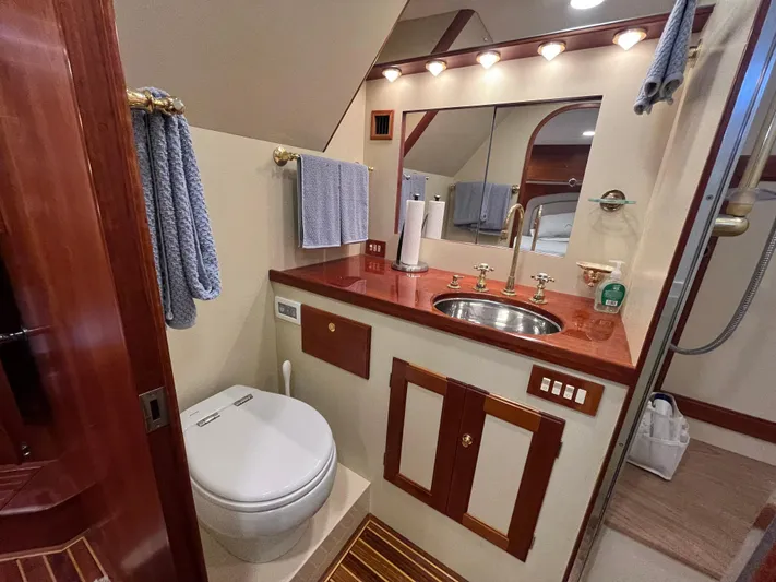 Angus III Yacht Photos Pics Luxurious bathroom in 1998 Alden 56 PHMY yacht with elegant fixtures and wood accents.