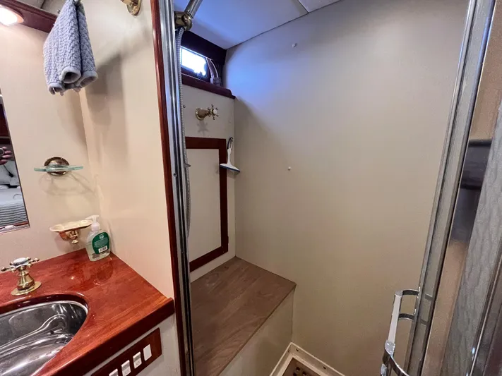 Angus III Yacht Photos Pics Bathroom interior of 1998 Alden 56 PHMY yacht with wooden accents and modern fixtures.