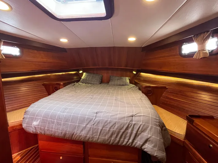 Angus III Yacht Photos Pics Luxurious cabin interior of 1998 Alden 56 PHMY yacht with cozy bedding.