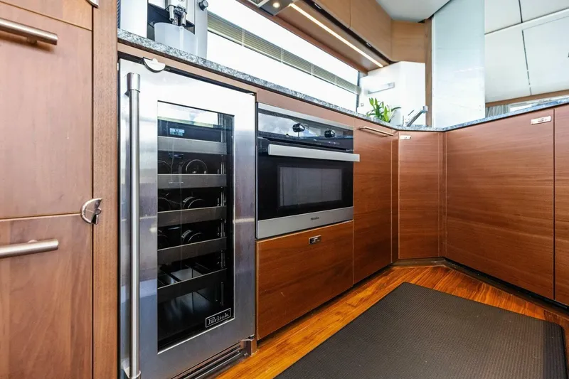 3bboys Yacht Photos Pics Luxurious kitchen in 2018 Princess Y75 yacht with modern appliances and wood cabinetry.