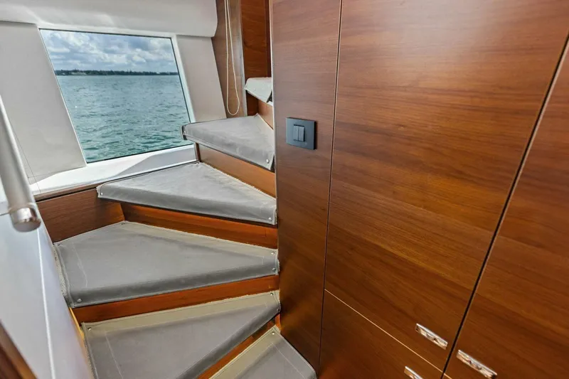 3bboys Yacht Photos Pics Staircase with wooden finish inside 2018 Princess Y75 yacht, overlooking ocean view.