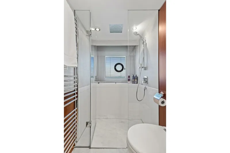 3bboys Yacht Photos Pics Luxurious bathroom in 2018 Princess Y75 yacht with glass shower and modern fixtures.