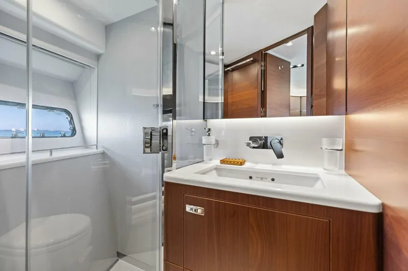 3bboys Yacht Photos Pics Luxurious bathroom in 2018 Princess Y75 yacht with modern fixtures and wooden cabinetry.