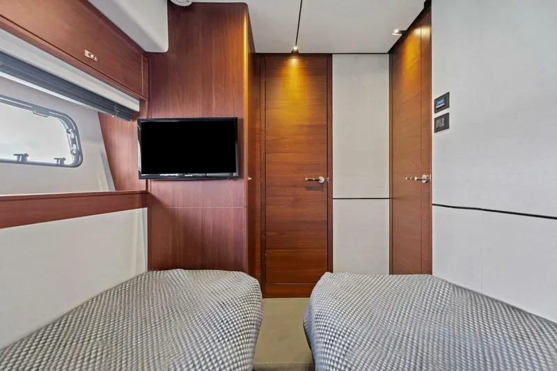 3bboys Yacht Photos Pics Luxurious interior of 2018 Princess Y75 yacht with twin beds and TV.