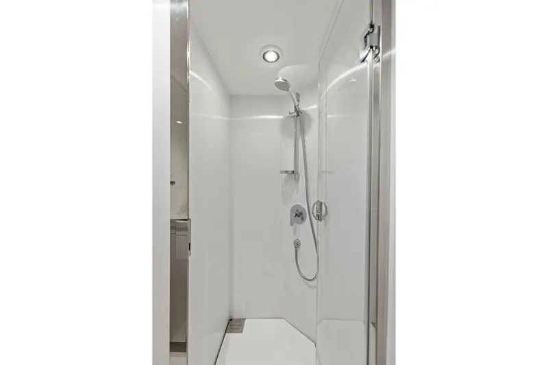 3bboys Yacht Photos Pics Modern shower in 2018 Princess Y75 yacht, featuring sleek white design and chrome fixtures.