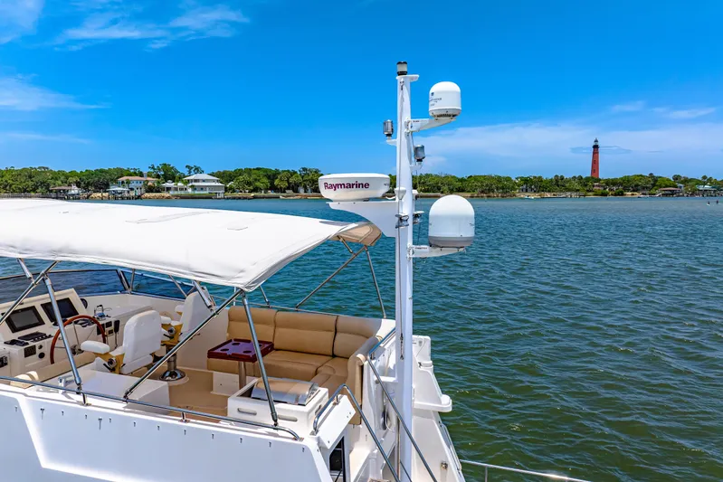 Grazie Yacht Photos Pics 2008 Grand Banks 47 Classic yacht with Raymarine equipment, cruising near a lighthouse.