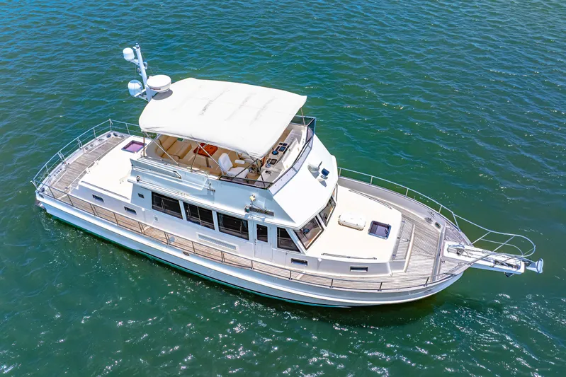 Grazie Yacht Photos Pics 2008 Grand Banks 47 Classic yacht cruising on open water, aerial view.