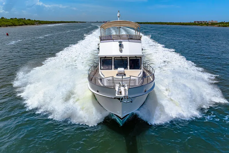 Grazie Yacht Photos Pics 2008 Grand Banks 47 Classic yacht cruising on open water, creating a dynamic wake.