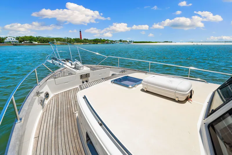 Grazie Yacht Photos Pics 2008 Grand Banks 47 Classic yacht cruising on a sunny day with scenic coastal view.