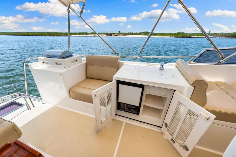 Grazie Yacht Photos Pics Outdoor seating and kitchenette on 2008 Grand Banks 47 Classic yacht, with ocean view.