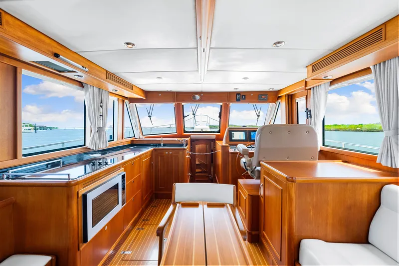 Grazie Yacht Photos Pics Interior of 2008 Grand Banks 47 Classic yacht with wood finish and panoramic windows.