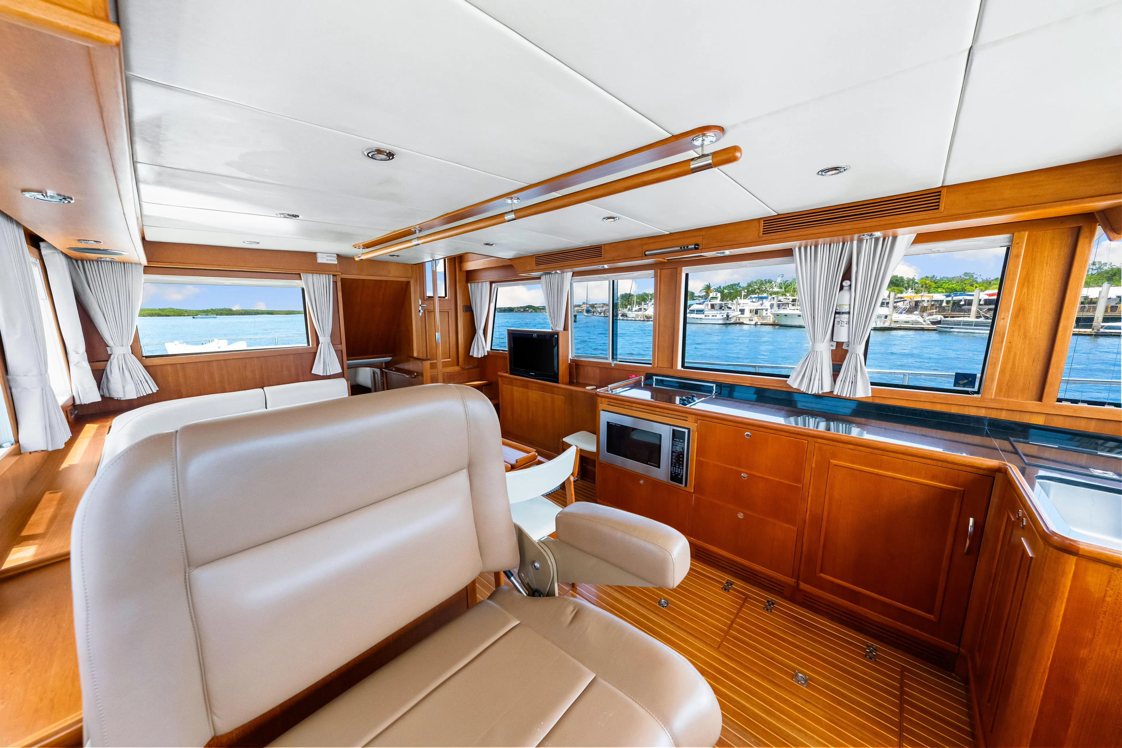 Grazie Yacht Photos Pics Luxurious interior of 2008 Grand Banks 47 Classic yacht with wood finish and waterfront view.