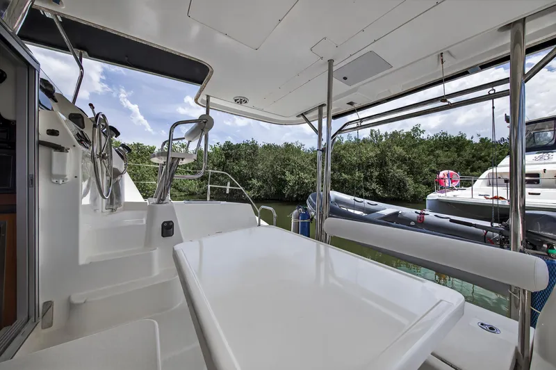 Cocoa Bella Yacht Photos Pics 2011 Leopard 38 yacht interior with steering wheel, table, and outdoor view.