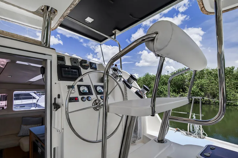 Cocoa Bella Yacht Photos Pics Helm of 2011 Leopard 38 catamaran with steering wheel and controls, under blue sky.